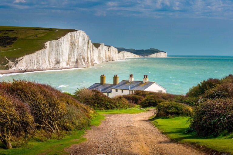 View of chalk cliffs, sea and cottages