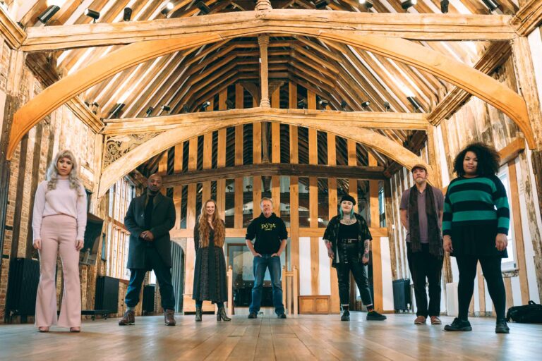 group of writers and performers in a barn