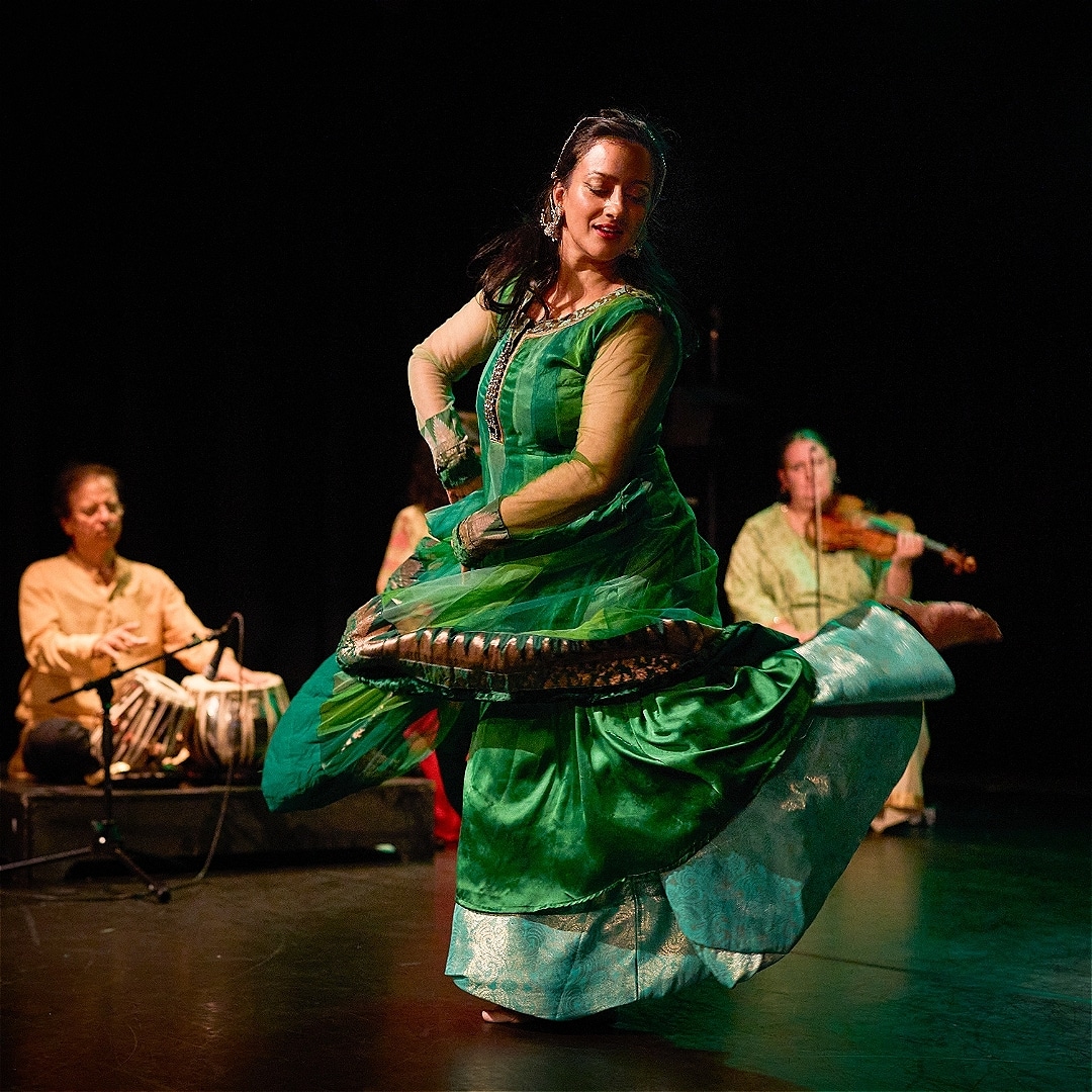 Kathak dancer performs in front of two musicians
